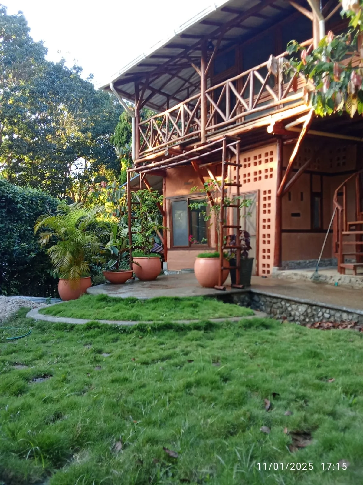 Ochre exterior of Casa Canela surrounded by greenery